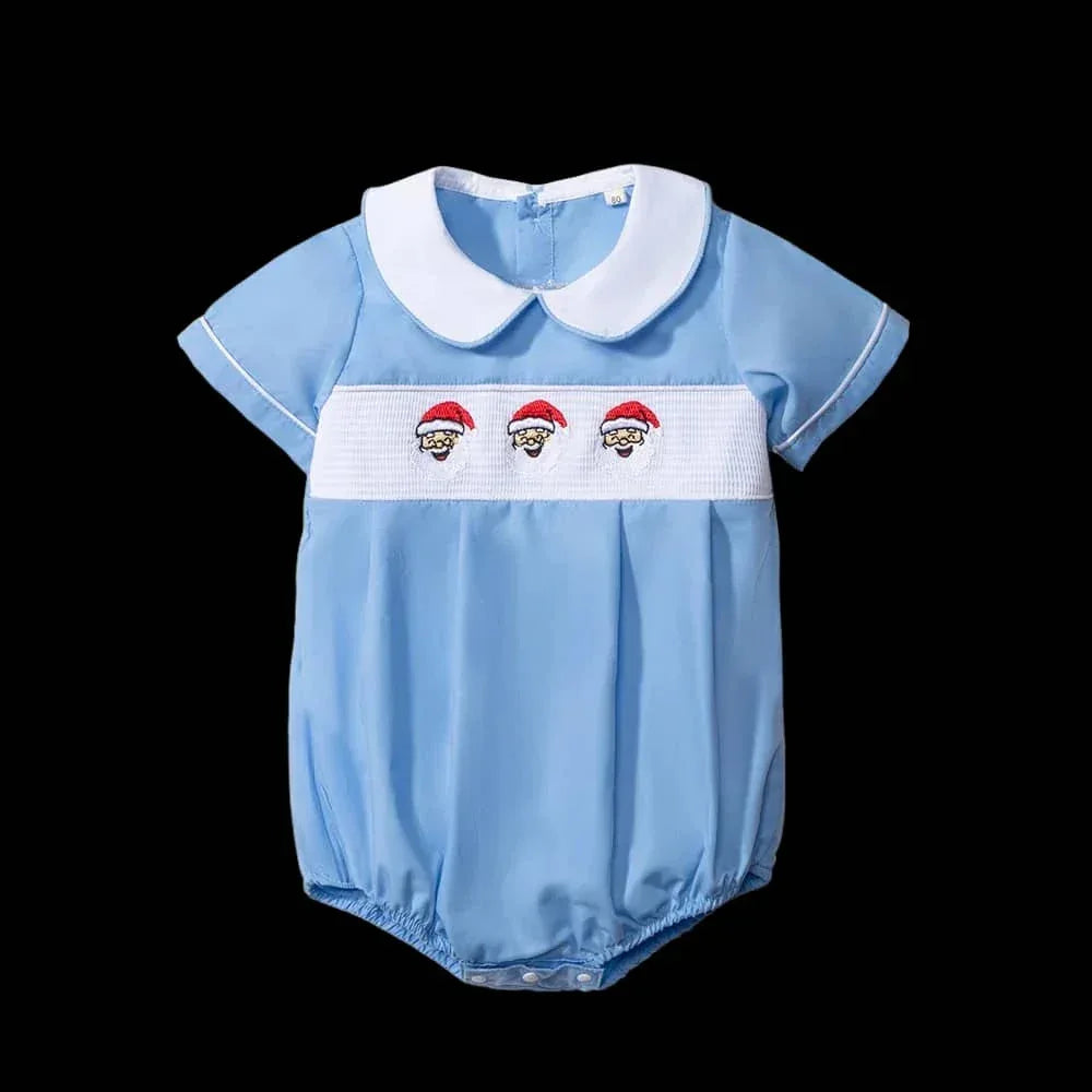 Front view of the 'Santa Cutie' Peter Pan Collar Romper in Boca blue, showcasing embroidered Santa faces on the chest and a classic Peter Pan collar.