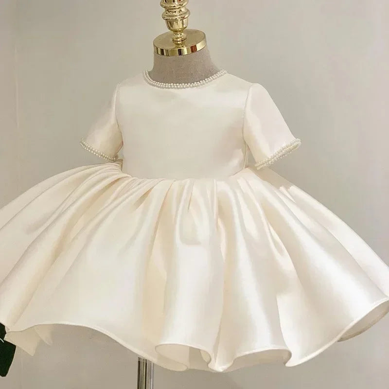 White dress on a mannequin against a plain background