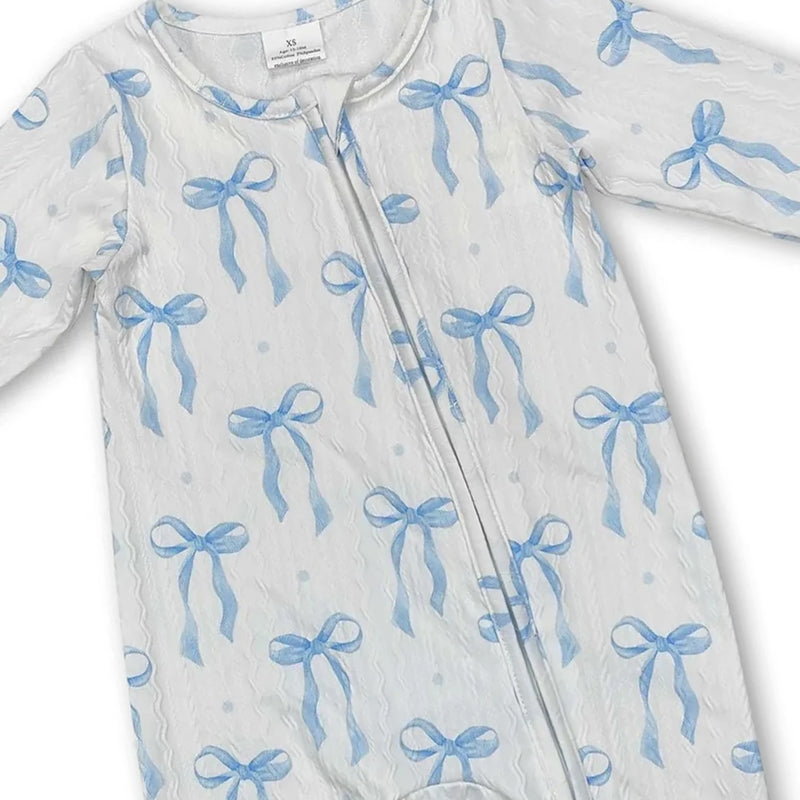 Close-up of the front of the Little Blue Bow zippered long sleeve romper featuring a gentle pattern of blue bows, perfect for little ones.