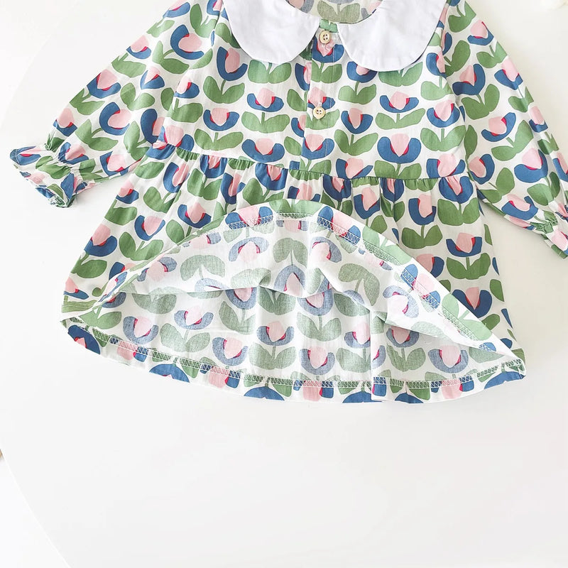 The "Mariella" Floral Print Peter Pan Collar Dress featuring a green floral pattern with vibrant colors, designed for little girls.