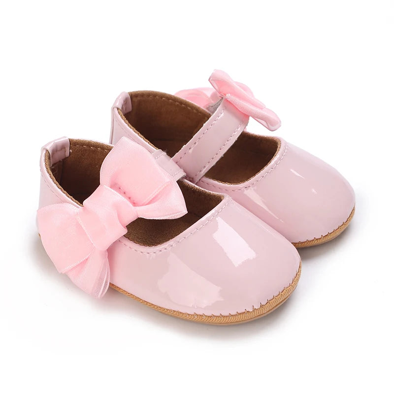 Serena Bow First Walker Shoes in pink featuring an adorable butterfly-knot bow, ideal for stylish infants.