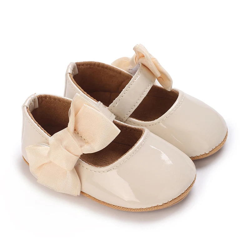 Serena Bow First Walker Shoes in beige with a charming butterfly-knot bow, designed for little walkers.