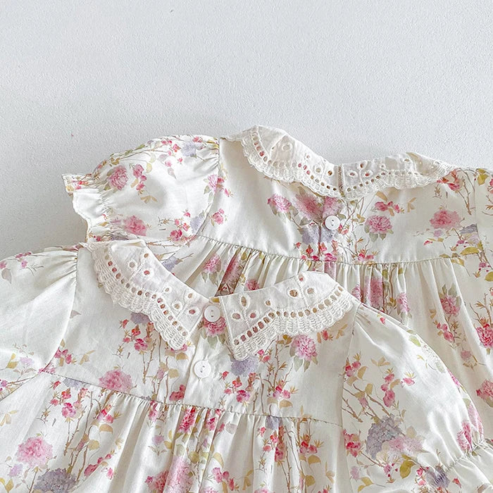 Two adorable Vintage Outfits showcasing floral designs with elegant collars, crafted for babies.