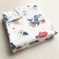 Two-sided children's Minky blanket with white background, cute ocean prints (whales, turtle, submarine) and raised dots.