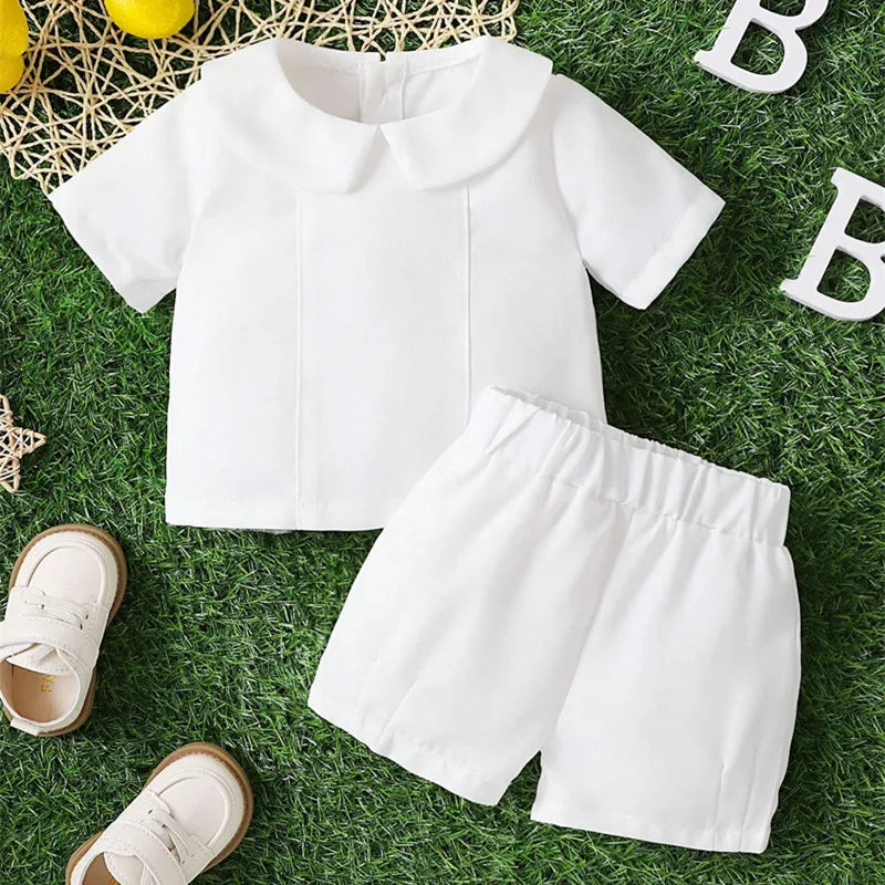 White baby boy 2-piece baptism set with Peter Pan collar shirt and shorts, made of combed cotton for warm weather.