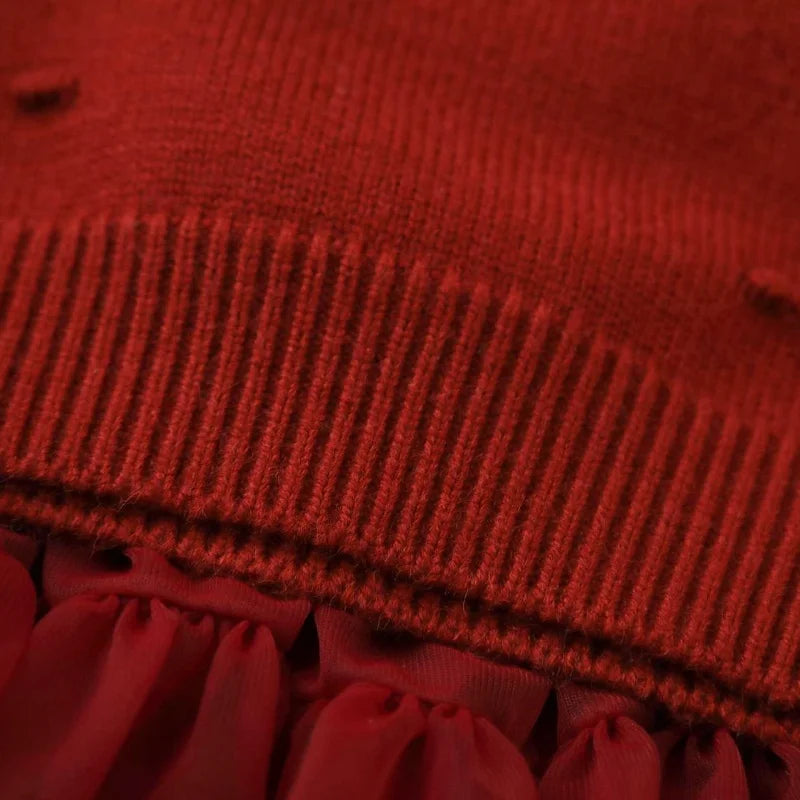 Close-up of the ribbed hem from the Strawberry Girls Knit Sweater and Tulle Skirt - Deep Red, emphasizing the quality finish of the outfit.