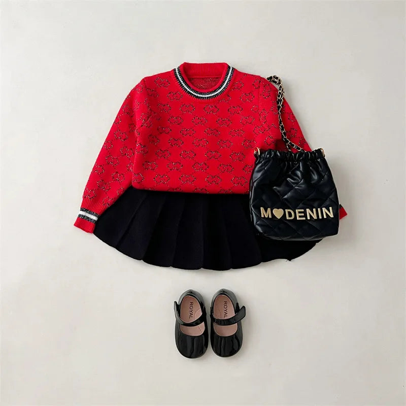 The 'Morgan' Classic Knit Skirt Set displayed in vibrant red with a stylish pullover sweater, pleated skirt, and matching accessories, perfect for young girls ages 4-6.