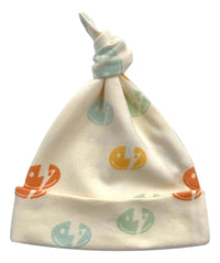 GOTS certified organic cotton baby hat with colorful smiley bolt print and knotted top. Chemical-free, softknit infant accessory.