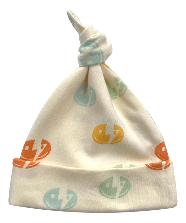 GOTS certified organic cotton baby hat with colorful smiley bolt print and knotted top. Chemical-free, softknit infant accessory.