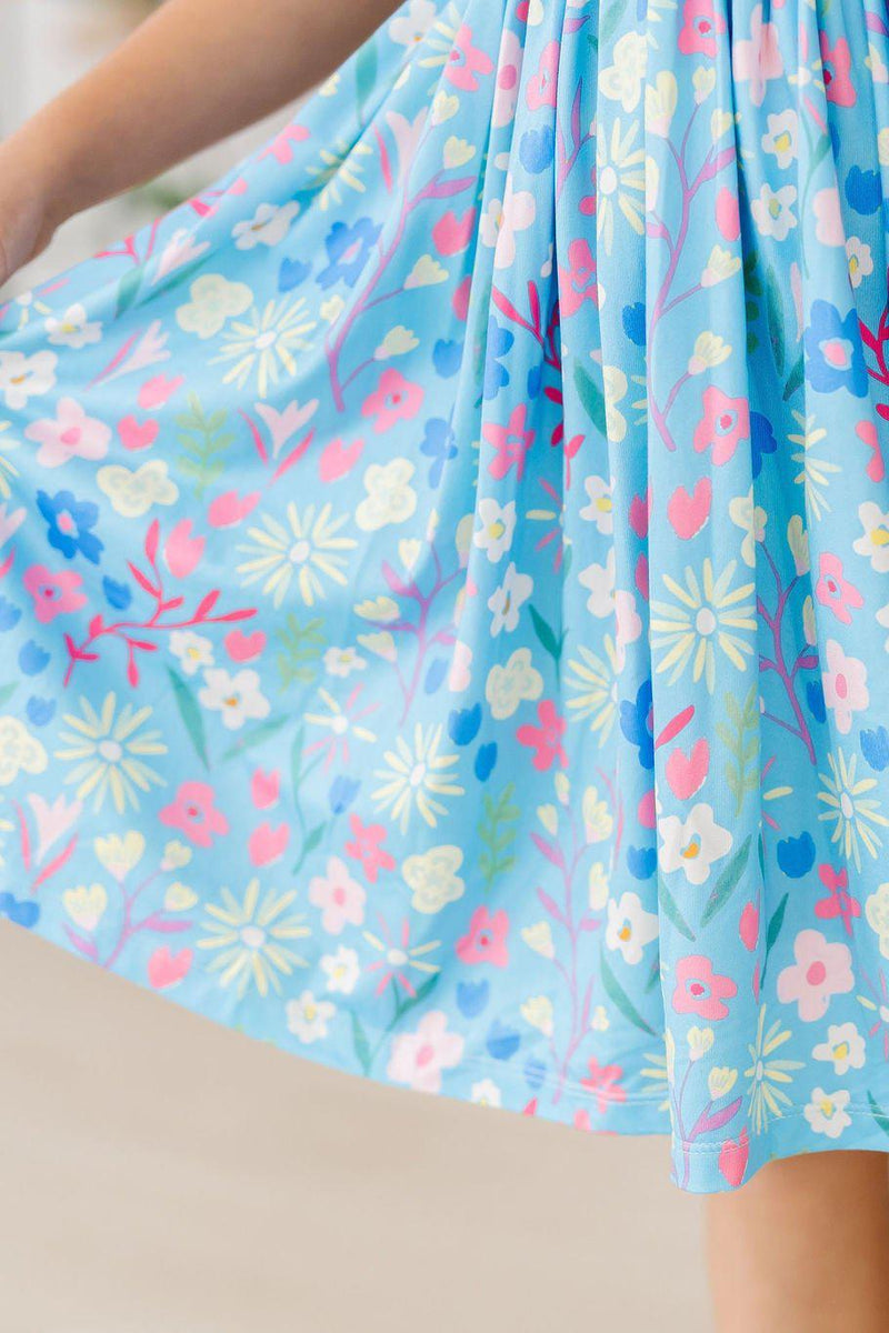 Close-up of the skirt of the Springtime Splendor Flutter Sleeve Twirl Dress highlighting the intricate floral design.