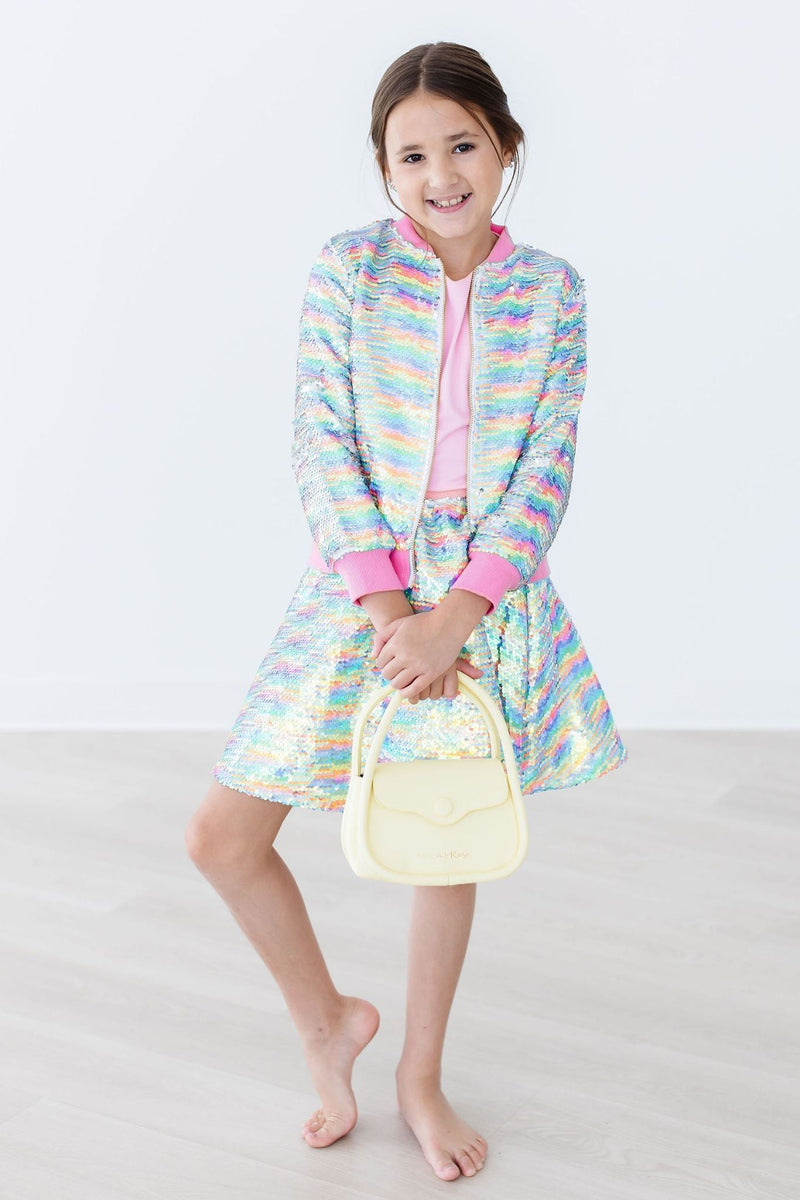 Girl posing with a stylish handbag in the Colorful Sprinkles Flip Sequin Twirl Skort for Girls, displaying a fun combination of comfort and fashion.
