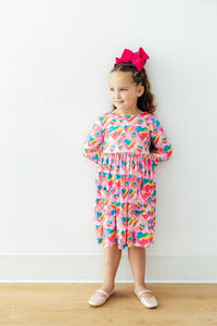 Sugar & Spice 3/4 Sleeve Pocket Twirl Dress worn by a girl in pink heart print with full twirl skirt and pink bow.