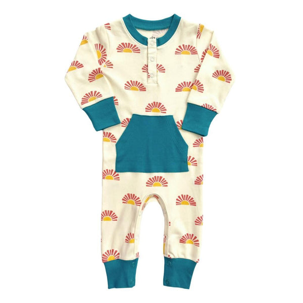 GOTS certified organic cotton playsuit in Sunrise print featuring teal trim, front pocket, and long sleeves.