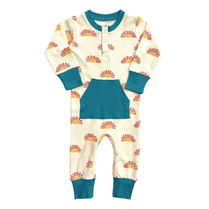 GOTS certified organic cotton playsuit in Sunrise print featuring teal trim, front pocket, and long sleeves.