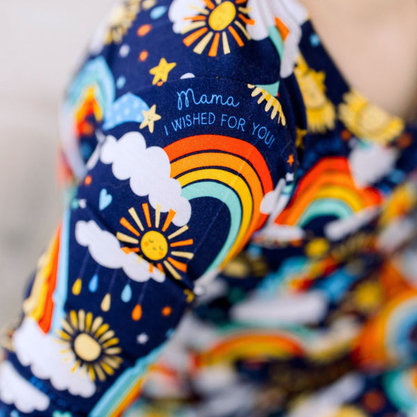 Blue Here Comes the Sunshine print on The Second-Skin 2-Piece Long Sleeve Pajama with sun and rainbow motifs.