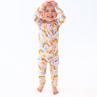Toddler playing outdoors in The Second-Skin Convertible Romper for Toddlers | Here Comes the Sunshine, ideal for fun and adventure, as it is a convertible romper for toddlers.