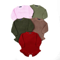 Stack of five chunky knit rompers in pink, green, brown, red, and lilac