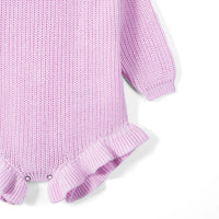 Side angle of lilac romper showing sleeve length, ribbed cuff, and ruffle hem