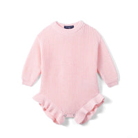 Light pink chunky knit baby romper with ribbed cuffs and ruffled leg openings on white background