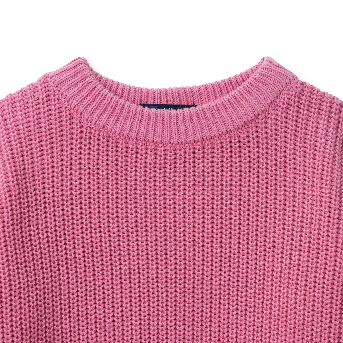 Close-up of rose pink garter stitch texture and ribbed crew neck collar with blue tag