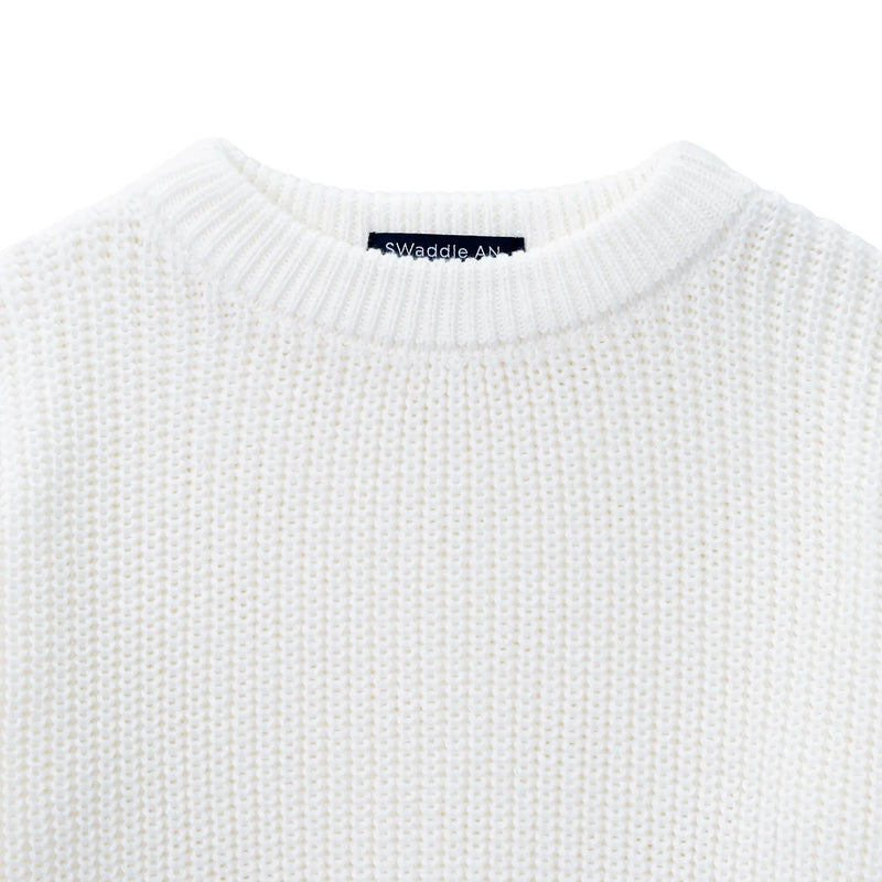 Close-up of ribbed crewneck collar showing navy SWaddle AN brand tag inside