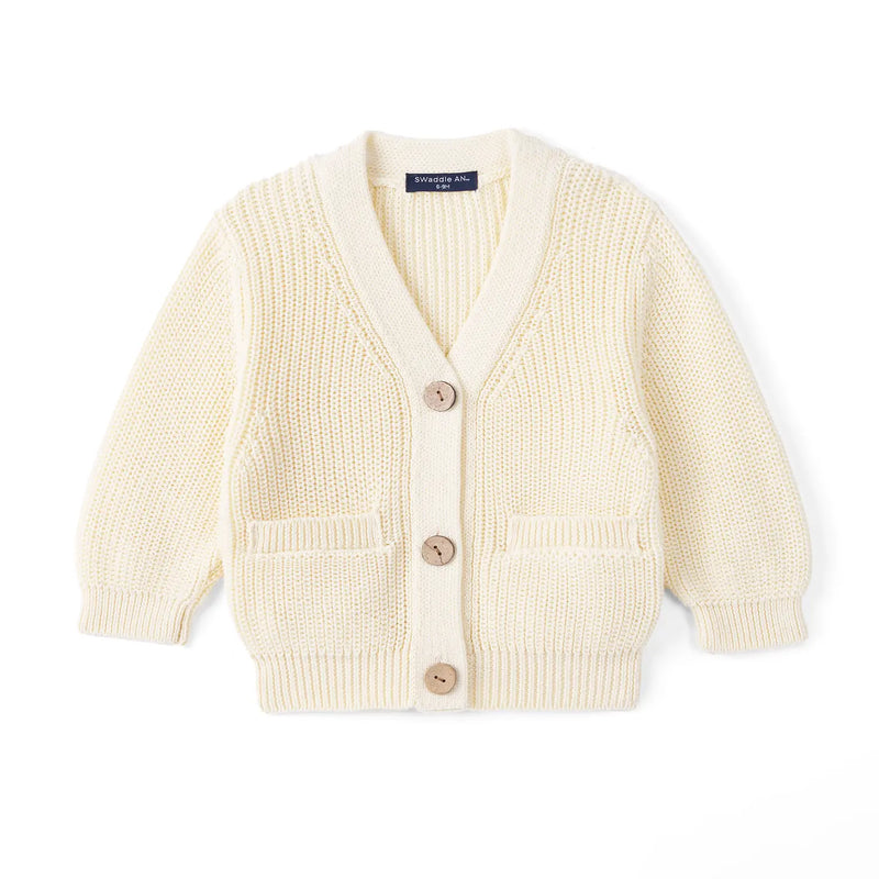 Cream baby cardigan flat lay with V-neck, three wooden buttons, two front pockets, and ribbed cuffs