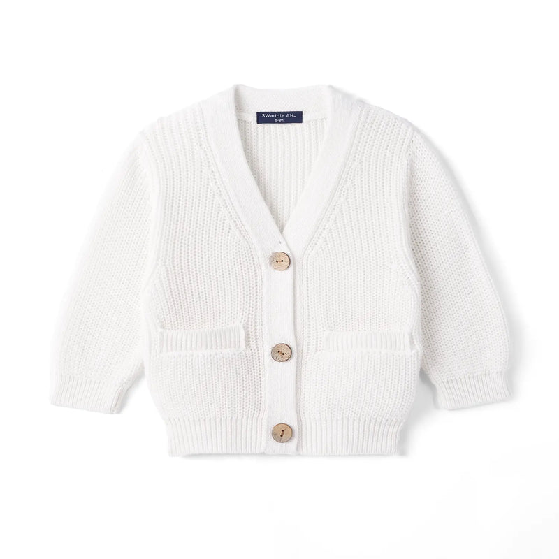 White baby cardigan with V-neck, three wooden buttons, and two front pockets against a plain background