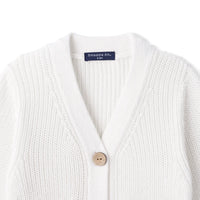 Close-up of white ribbed knit neckline showing top wooden button and navy SWaddle AN size tag
