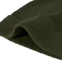 Macro view of vertical ribbing and folded cuff on soft cotton newborn beanie
