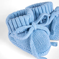 Close-up of light blue bootie knit texture, side tie knot, and stretchy ankle cuff