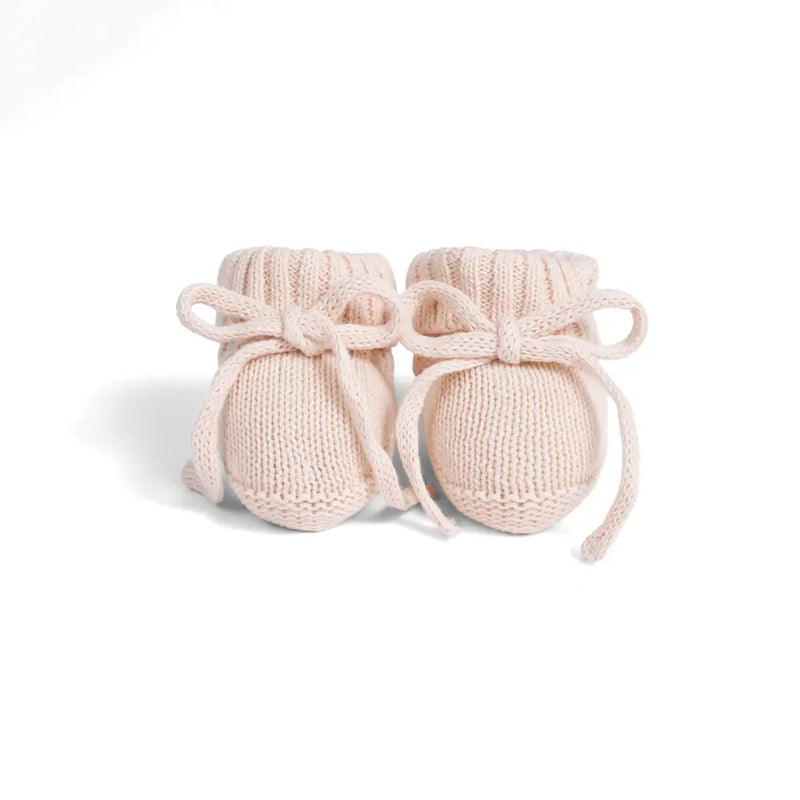 Frontal view of beige cotton booties showing symmetrical knit bows and textured elasticized cuffs