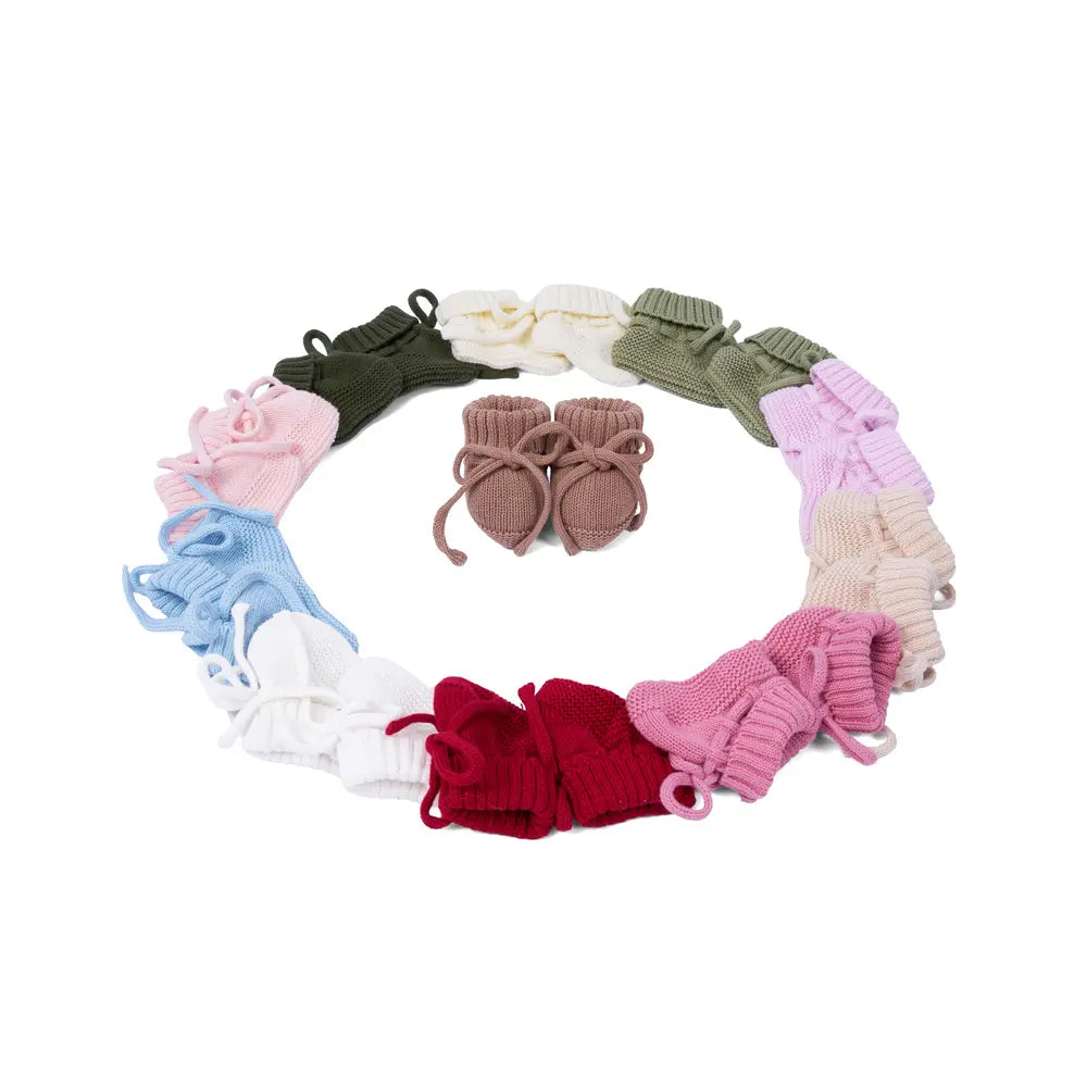 Circular arrangement of multi-colored booties surrounding a central pair of brown ones