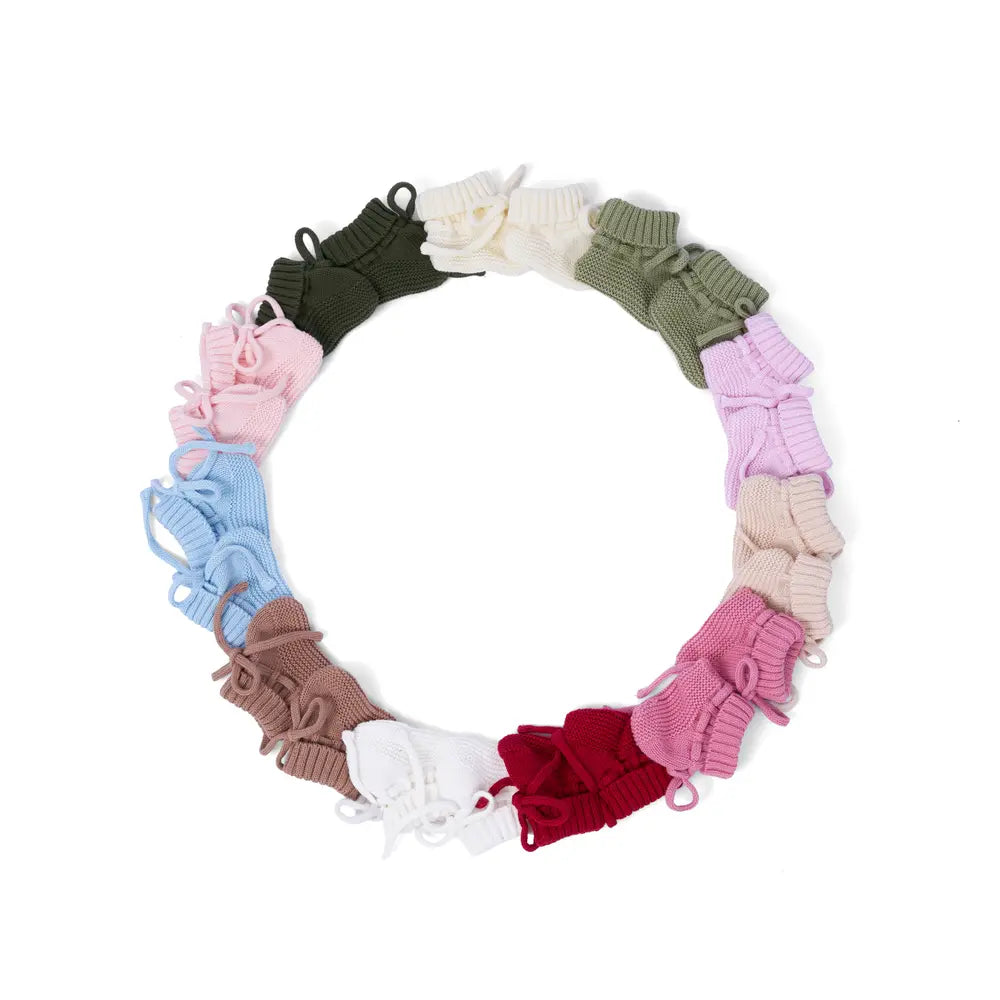Ten pairs of knitted booties arranged in a ring to display full color spectrum options