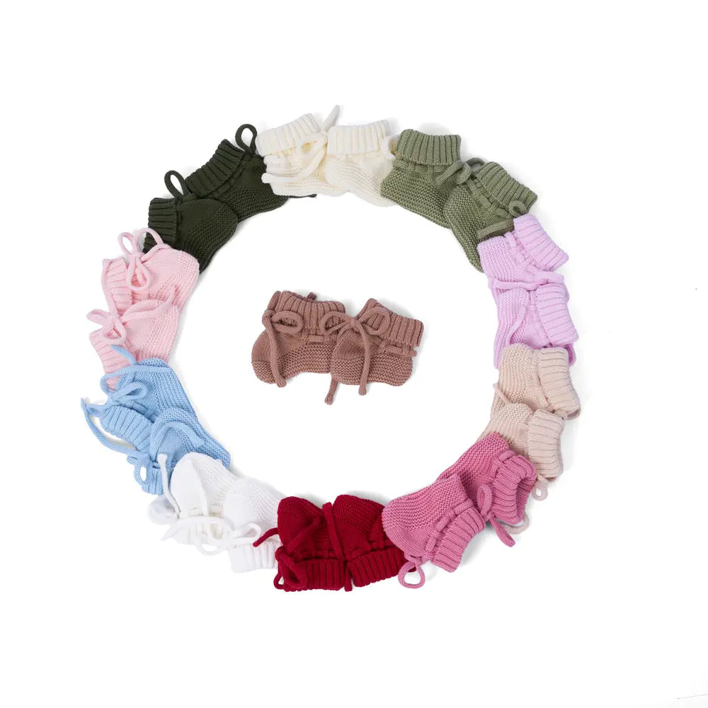 Top-down view of colorful bootie ring encircling brown pair, highlighting ribbed texture
