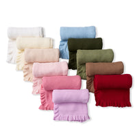 Ten folded baby blankets in various colors including blue, pink, green, and red with ruffled edges