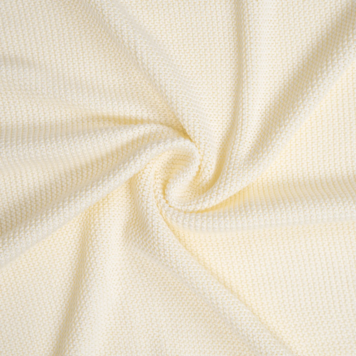 High-res macro of cream fabric swirls highlighting plush waffle-weave stitch pattern