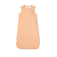 Peach fuzz bamboo sleep sack flat lay with diagonal zipper and rounded hem on white background