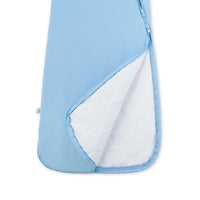 Open zipper revealing white quilted inner insulation layer of blue sleep sack