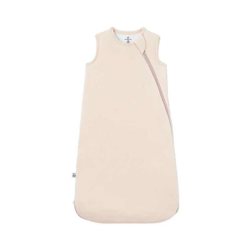 Sand-colored bamboo sleep sack flat lay with diagonal zipper and brand tag