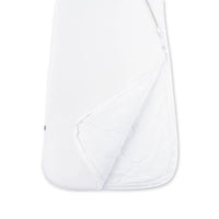 Folded hem revealing quilted inner insulation layer of white bamboo sleep sack