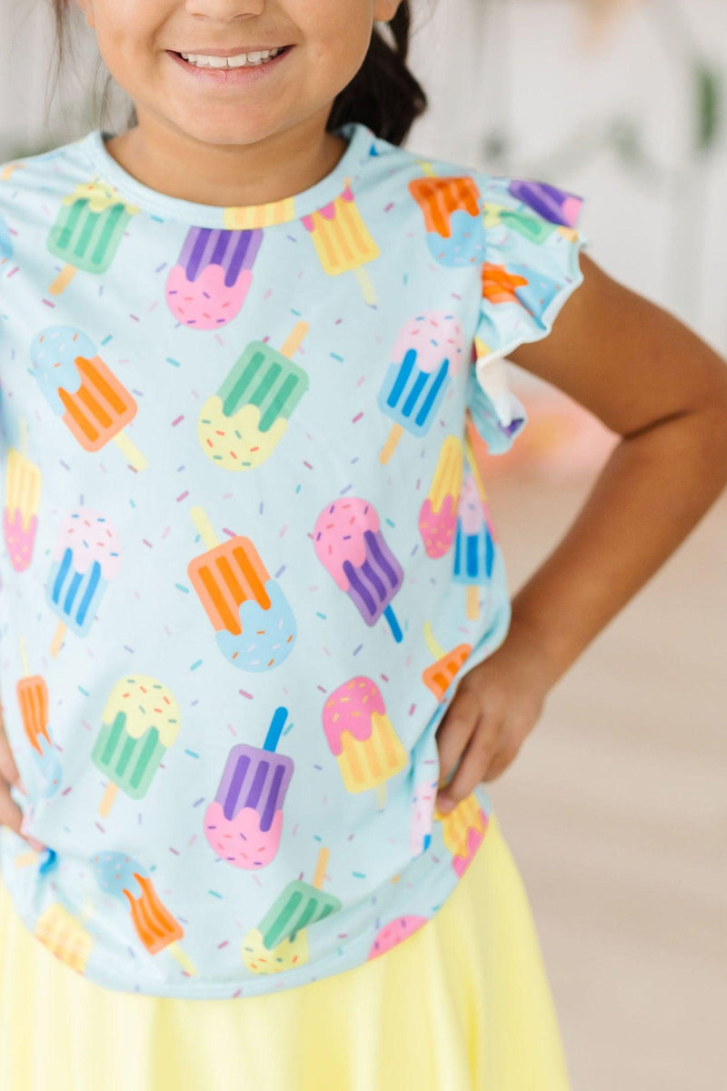 Adorable 'Sweet Treat' Ruffle Sleeve Tee for girls featuring colorful popsicle prints, perfect for playful outfits and summer fun.