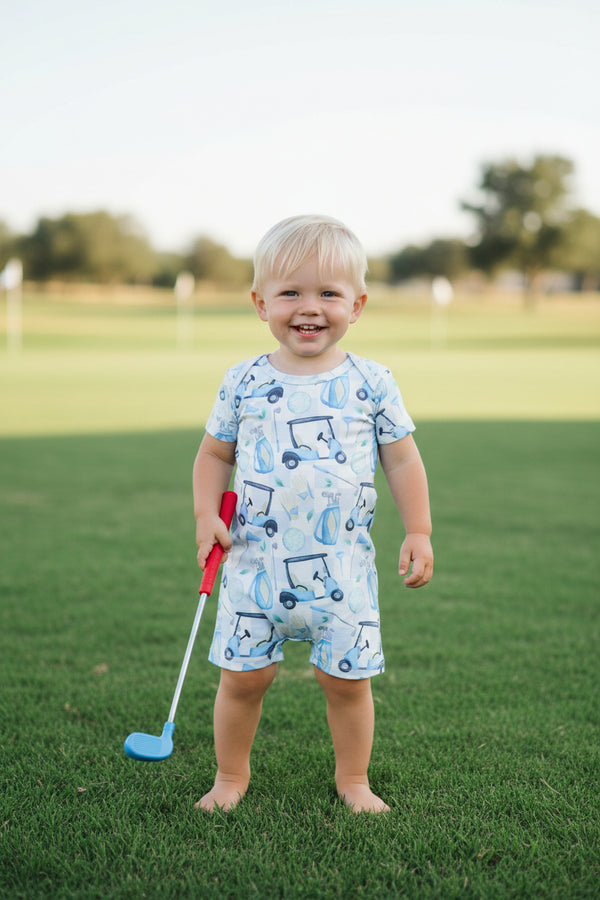 Baby romper with golf cart pattern on a white background