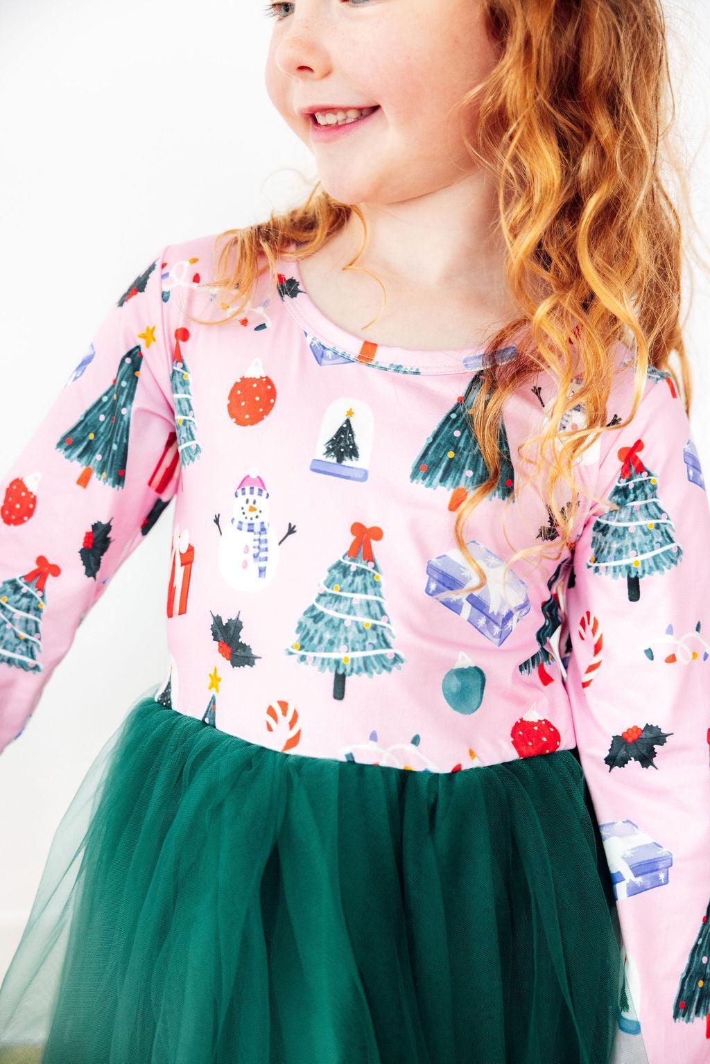 Pink long sleeve dress with Christmas print and green tutu skirt for little dancers. festive holiday attire for play and special occasions.