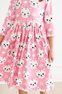 Unicorn Kitties pink 3/4 sleeve twirl dress with pockets, featuring white cat faces, unicorn horns, and rainbow accents.