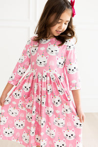 Girl in pink Unicorn Kitties 3/4 sleeve pocket twirl dress with unicorn-cat print.