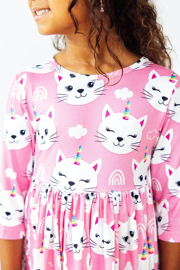Unicorn Kitties pink 3/4 sleeve pocket twirl dress with white cat faces and rainbow horns.
