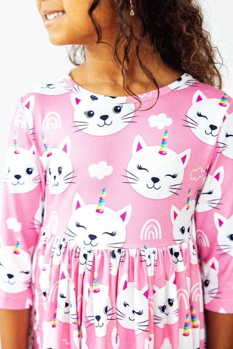 Unicorn Kitties pink 3/4 sleeve pocket twirl dress with white cat faces and rainbow horns.