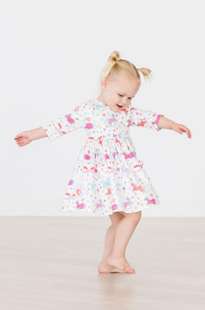 Cute little girl wearing the Unicorn Wish 3/4 Sleeve Pocket Twirl Dress for Girls, perfect for birthday parties and playdates.
