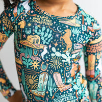 The Second-Skin 2-Piece Long Sleeve Pajama in Wild West print with hand-drawn desert motifs.