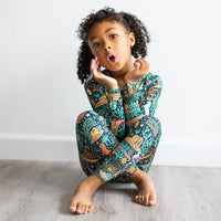 Child wearing The Second-Skin 2-Piece Long Sleeve Pajama | Wild West, with vibrant hand-drawn prints.